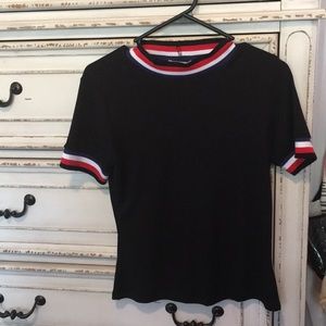 Red. White, and blue rimmed shirt.